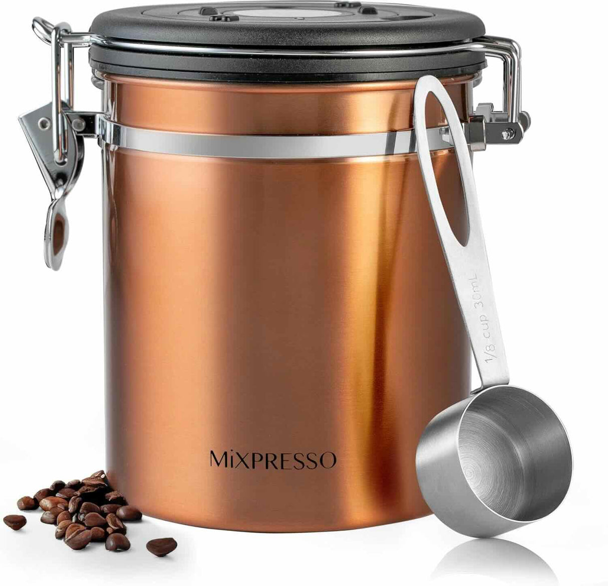 A copper-colored stainless steel coffee bean canister with a black lid and silver clasp, shown with a metal measuring scoop and scattered coffee beans on a white background.