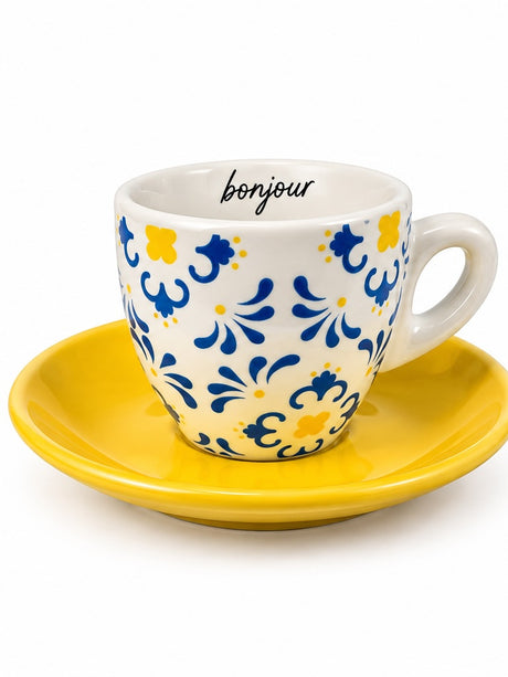 Bonjour espresso cup with blue and yellow floral pattern on a bright yellow saucer, front view