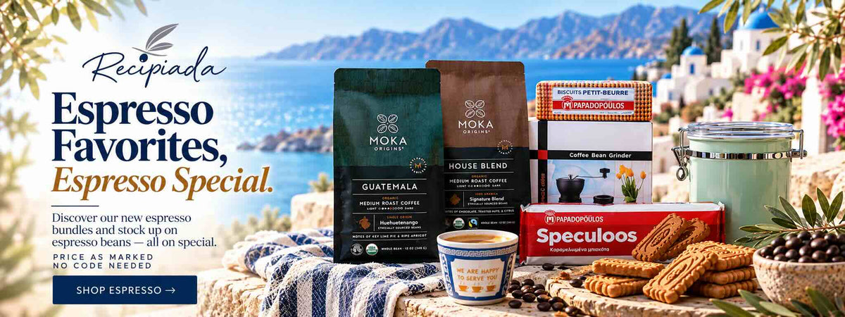 A promotional coffee assortment display on a stone table by the sea, featuring Moka Coffee products including Guatemala and House Blend espresso beans, a coffee bean grinder, a cup of espresso, Speculios cookies, and a mint jar, with the text 'Recipiada Espresso Favorites, Espresso Special.' and a scenic coastal background.