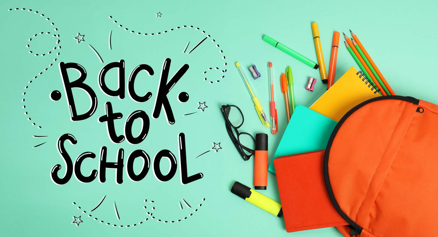 Back to school text with stationery items on a teal background