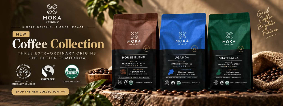 Three Moka Organic coffee bags displayed on a rustic wood surface with coffee beans and burlap. The bags are colored brown, blue, and green, representing three different coffee blends: House Blend, Uganda, and Guatemala.