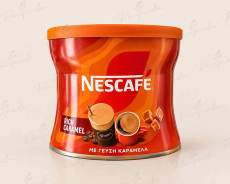 A cylindrical red and orange canister of Nescafe Rich Caramel coffee, featuring the white Nescafe logo and illustrations of a caramel coffee cup and chocolate pieces, set against a light beige background with faint watermarks.