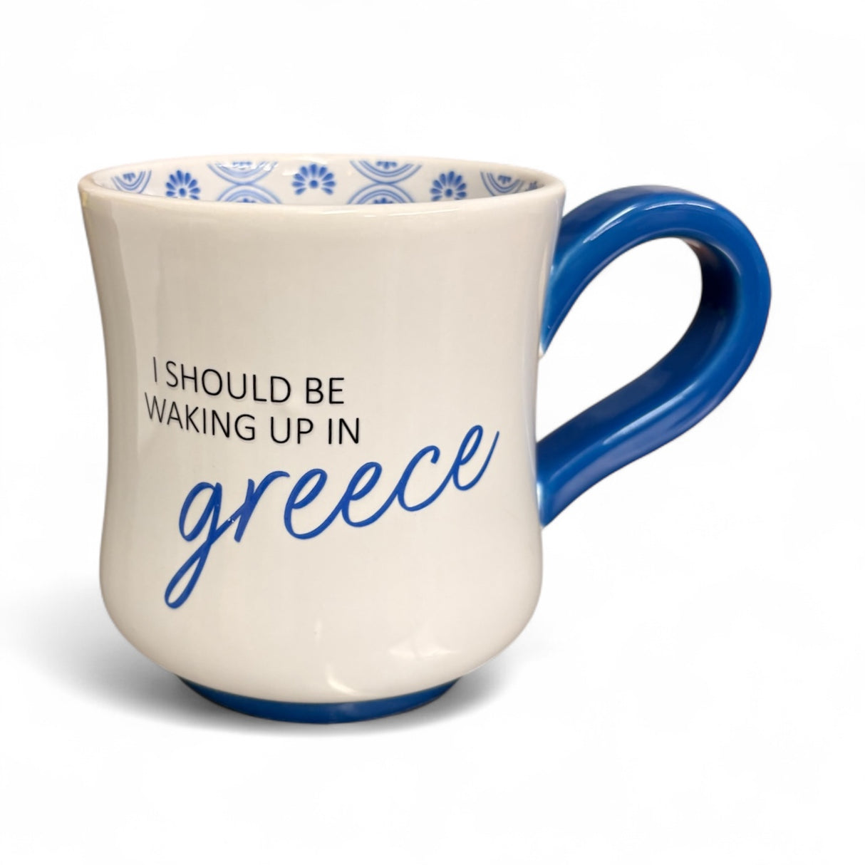 White mug with blue interior, blue handle, and text 'I Should Be Waking Up In Greece' on a white background